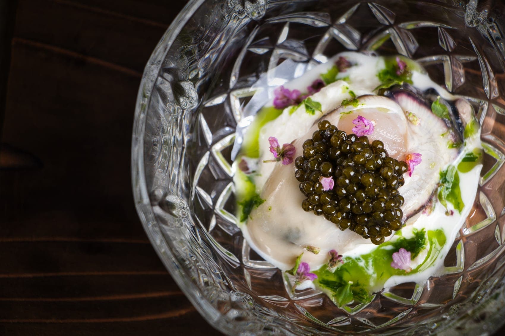 Oyster with caviar, served in cut crystal